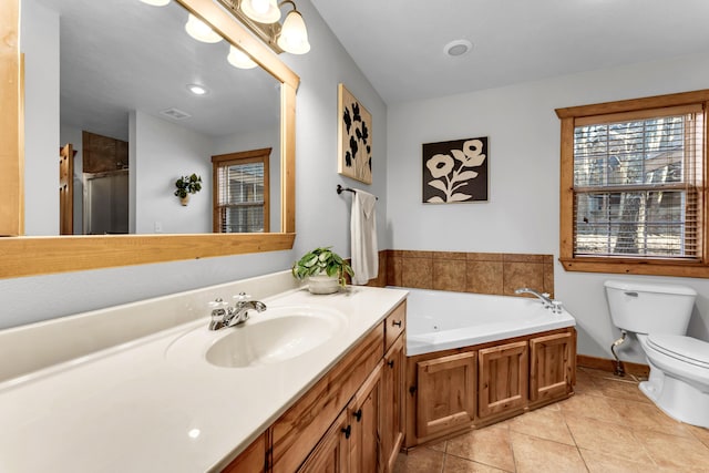 full bathroom with plus walk in shower, toilet, vanity, and tile patterned flooring