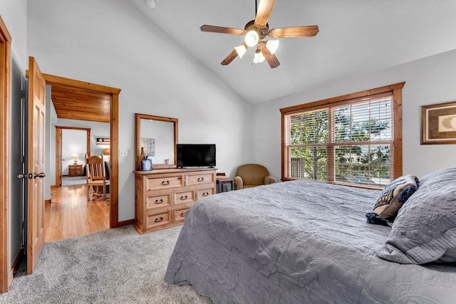 bedroom with light carpet, high vaulted ceiling, and ceiling fan