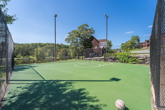 view of sport court with a water view