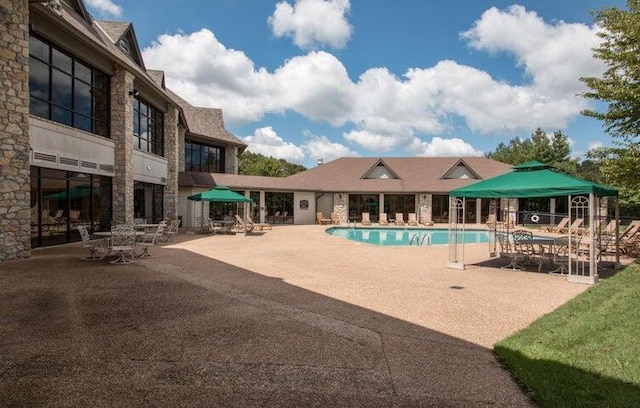 view of swimming pool with a patio area