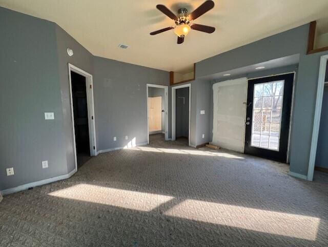 unfurnished bedroom featuring access to exterior, carpet floors, and ceiling fan