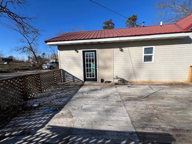 rear view of property featuring a deck