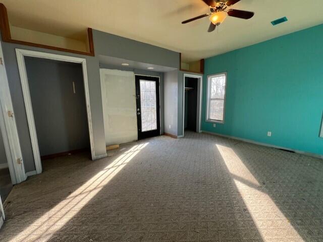 unfurnished bedroom featuring carpet floors and ceiling fan