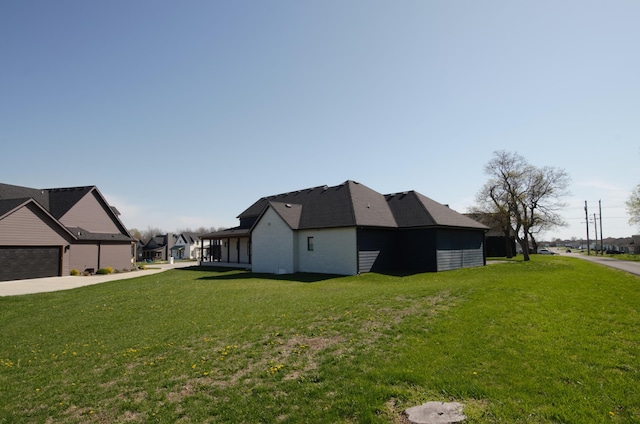 view of side of property with a yard