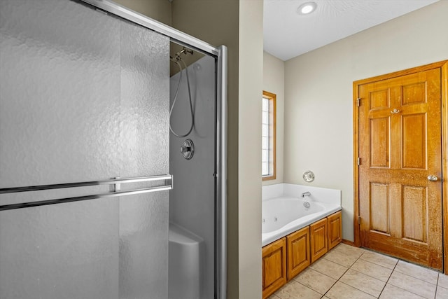 bathroom with separate shower and tub and tile patterned floors