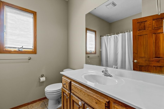 bathroom with vanity, tile patterned floors, and toilet