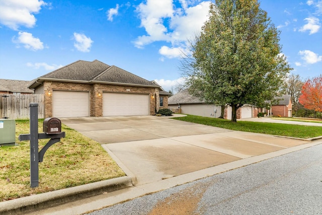 view of front of property featuring a garage and a front lawn