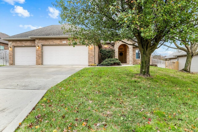 view of front of property featuring a garage and a front lawn