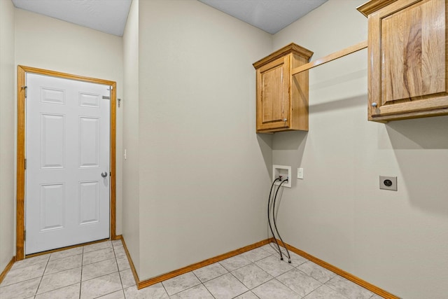 clothes washing area featuring washer hookup, light tile patterned flooring, cabinets, and hookup for an electric dryer