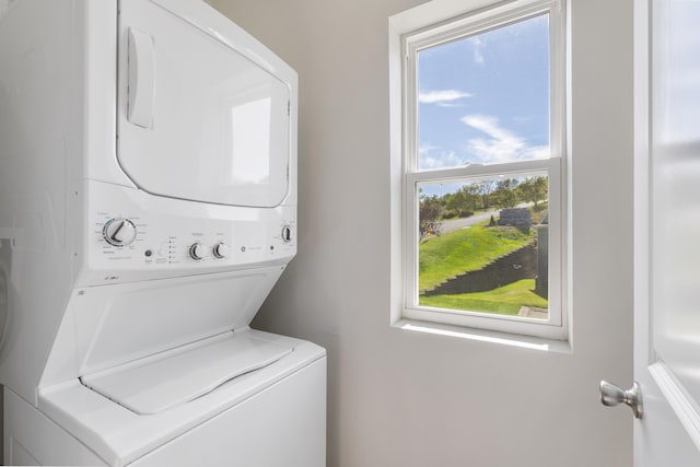 clothes washing area with laundry area and stacked washer / drying machine