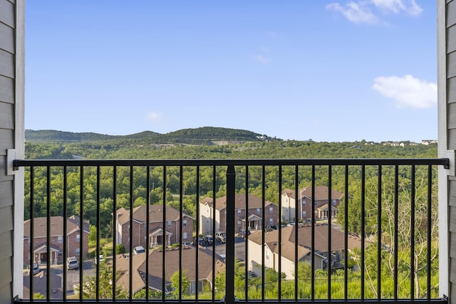 balcony with a residential view and a mountain view