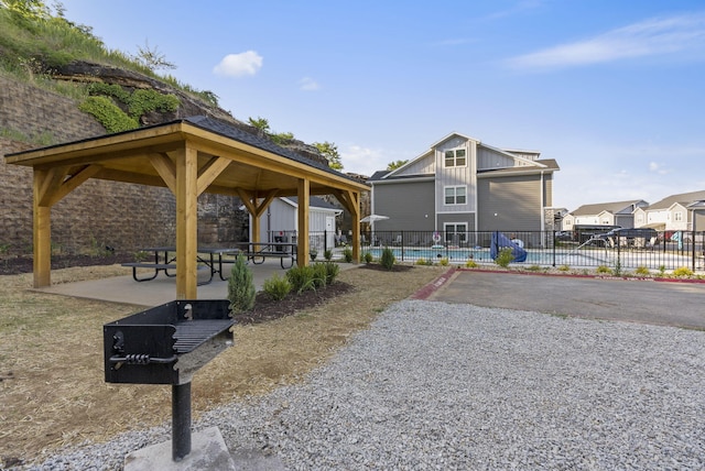surrounding community with a patio, a gazebo, fence, and a residential view