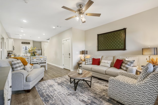 living room with recessed lighting, dark wood-style flooring, ceiling fan, and baseboards