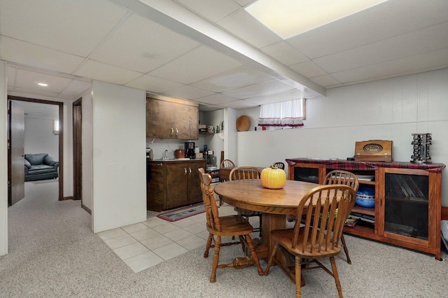 dining space with a drop ceiling