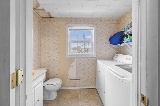 bathroom featuring tile patterned floors, vanity, toilet, and washer and dryer