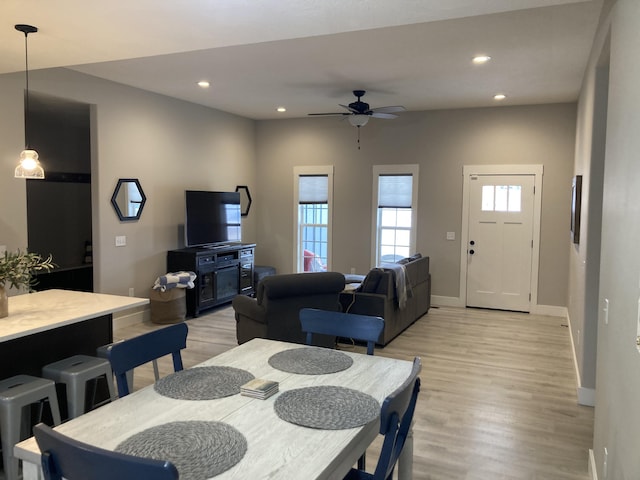 dining area featuring ceiling fan and light wood-type flooring