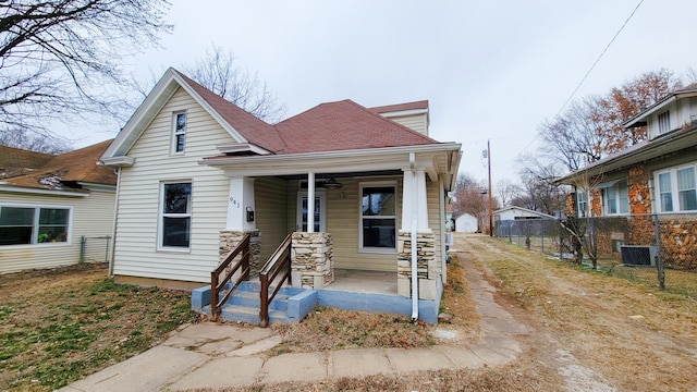 bungalow-style house with central AC and covered porch