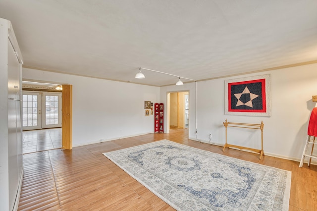 sitting room with crown molding, hardwood / wood-style flooring, and french doors