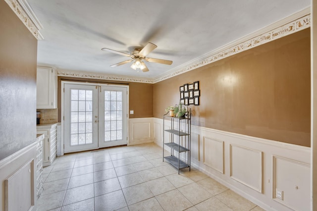 entryway with light tile patterned floors, french doors, and ceiling fan