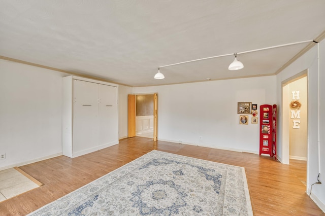 unfurnished room featuring ornamental molding and wood-type flooring