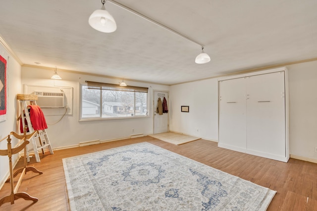 interior space with hardwood / wood-style floors and crown molding