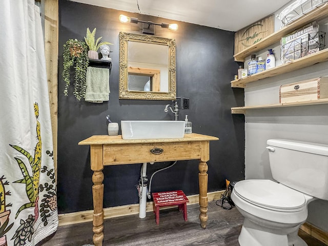 bathroom featuring hardwood / wood-style flooring, sink, and toilet