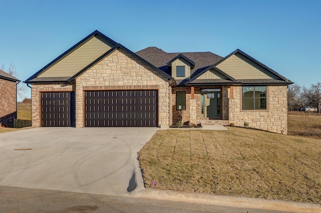 view of front facade with a front lawn, roof with shingles, driveway, and an attached garage