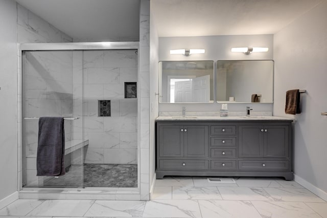 bathroom with vanity and a shower with door