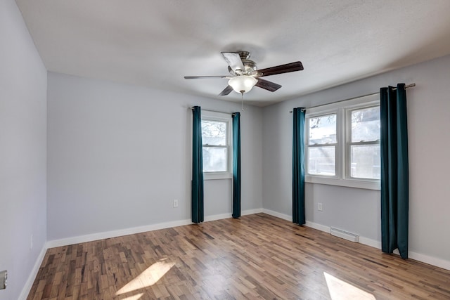 empty room featuring ceiling fan and light wood-type flooring