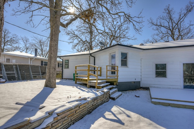 snow covered property featuring a deck