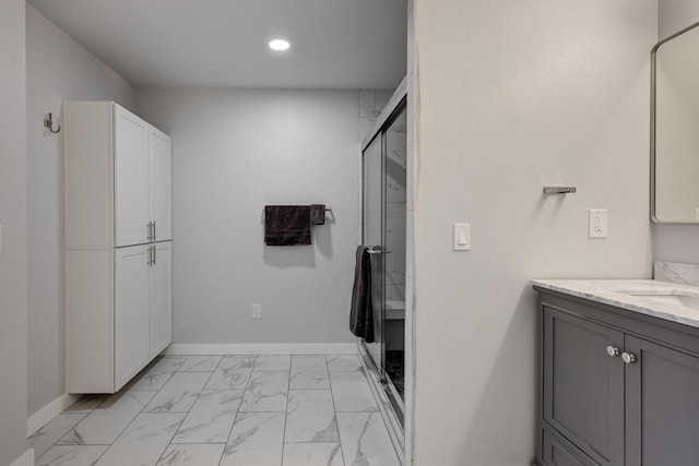 bathroom with vanity and a shower with door