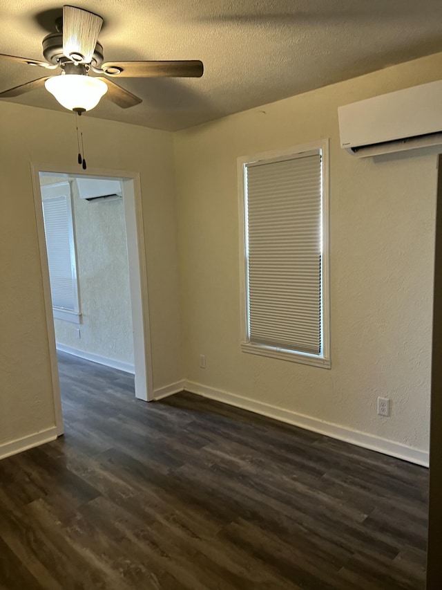 unfurnished room featuring ceiling fan, a textured ceiling, dark hardwood / wood-style floors, and a wall mounted AC