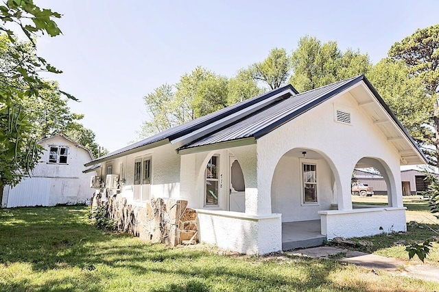 view of side of property with a lawn