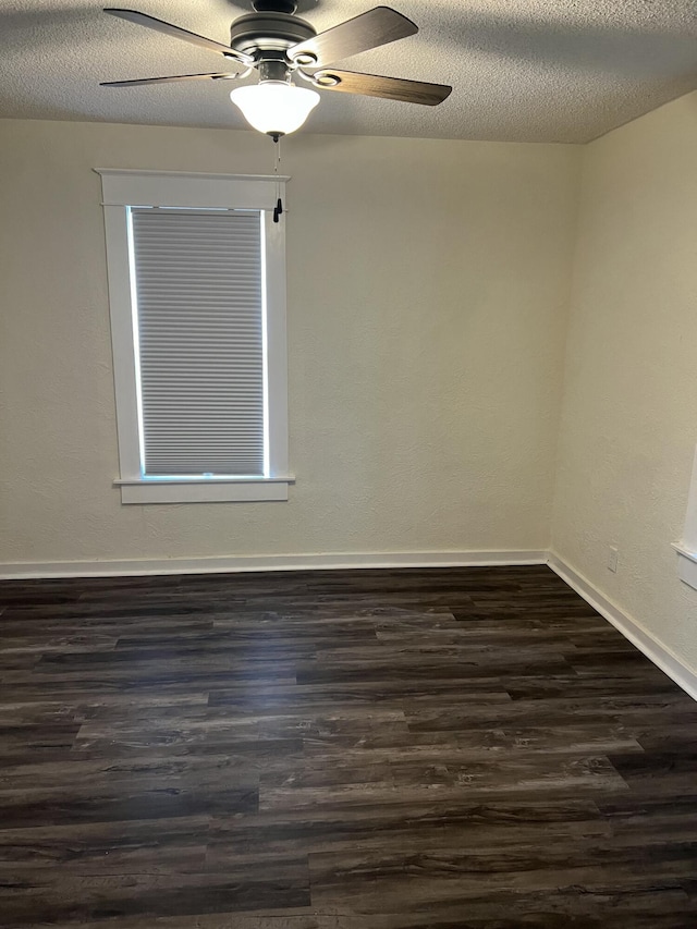 unfurnished room with ceiling fan, dark hardwood / wood-style flooring, and a textured ceiling