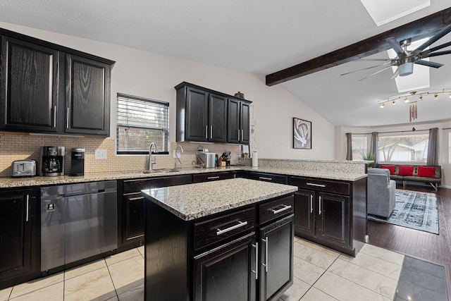 kitchen with sink, dishwasher, vaulted ceiling with beams, a center island, and decorative backsplash