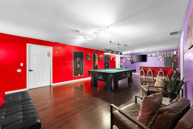 playroom featuring hardwood / wood-style flooring, pool table, and a textured ceiling