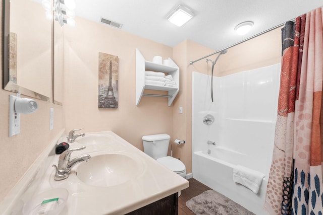 full bathroom featuring vanity, hardwood / wood-style floors, shower / tub combo with curtain, and toilet
