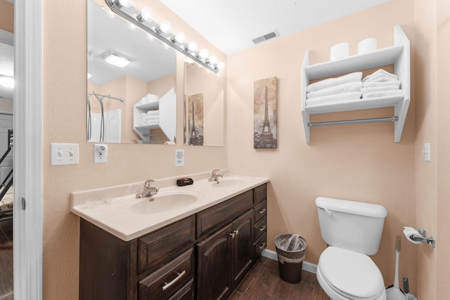 bathroom featuring vanity and toilet