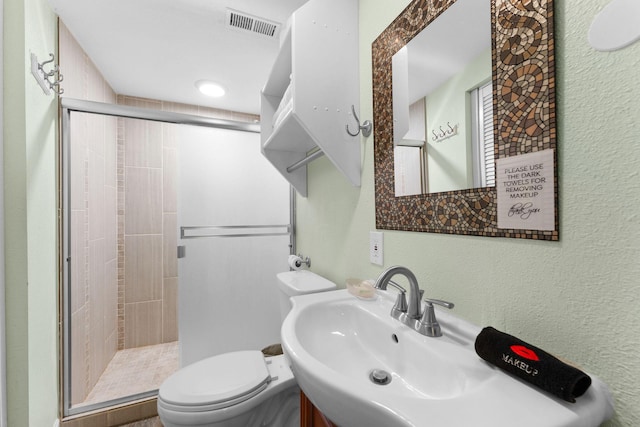 bathroom with toilet and an enclosed shower