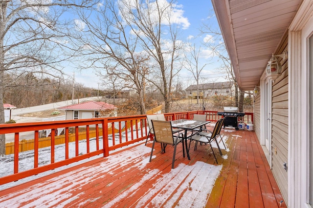 snow covered deck featuring a grill