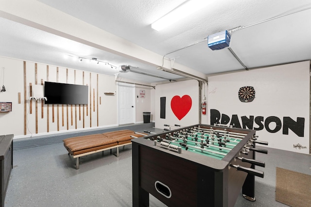 rec room featuring a textured ceiling