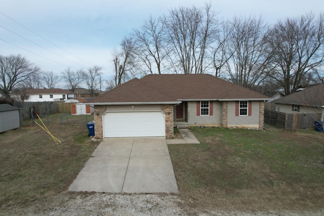 ranch-style house featuring a garage, a front lawn, and a storage unit