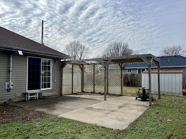 view of patio featuring a pergola and a shed