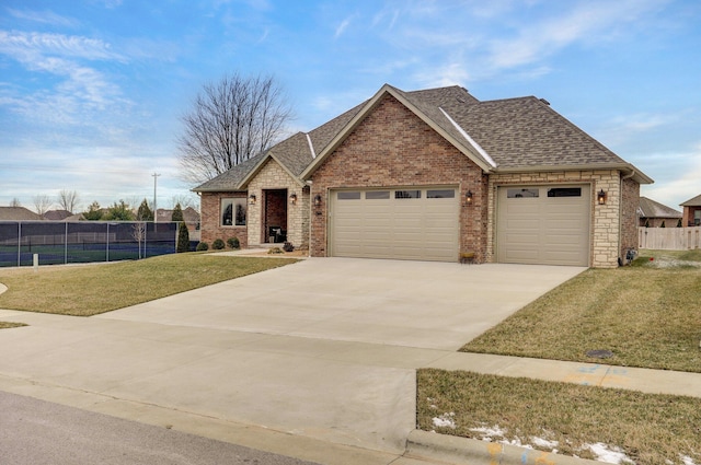 view of front of home featuring a garage and a front yard