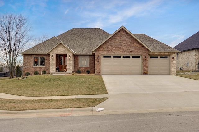 view of front of property with a garage and a front yard