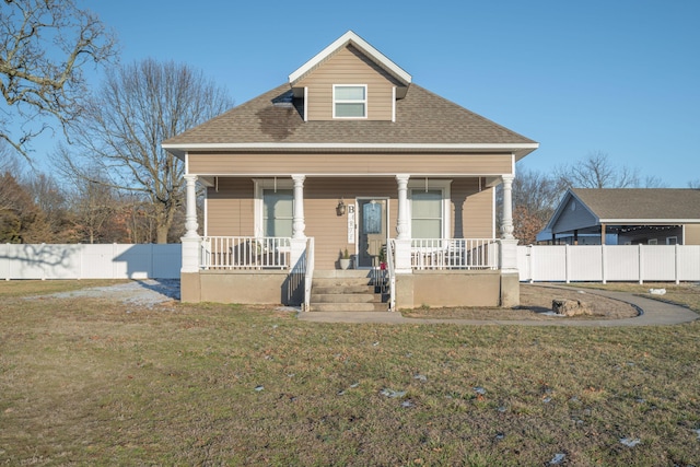 bungalow with a porch and a front lawn