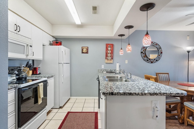 kitchen with sink, a breakfast bar, range with electric cooktop, white cabinets, and decorative light fixtures