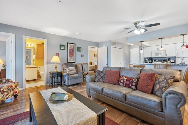 living room with ceiling fan and hardwood / wood-style floors