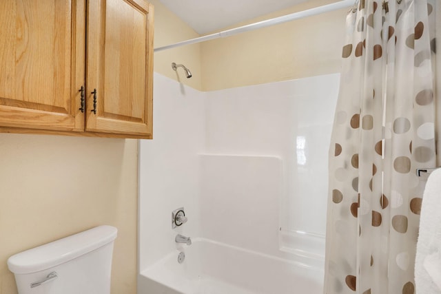 bathroom with shower / bath combination with curtain and toilet