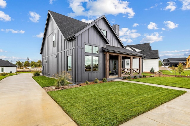 modern farmhouse with covered porch and a front lawn